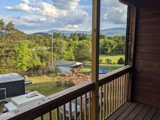 exterior space featuring a mountain view and a lawn