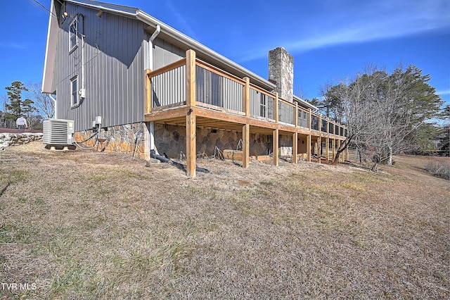 rear view of house with a wooden deck and central AC