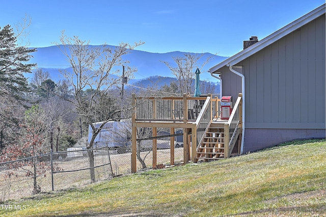 view of yard with a deck with mountain view