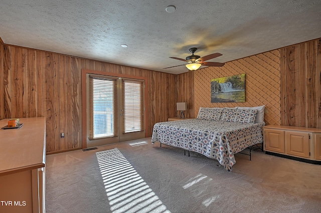 bedroom with light carpet, access to exterior, a textured ceiling, and ceiling fan