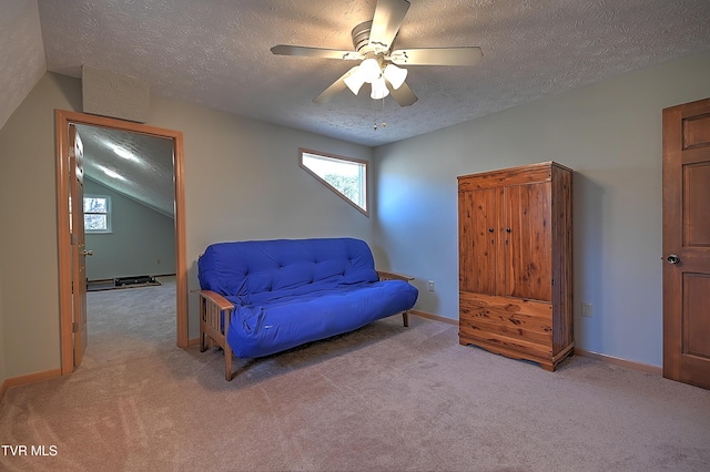 sitting room featuring ceiling fan, light carpet, and a textured ceiling