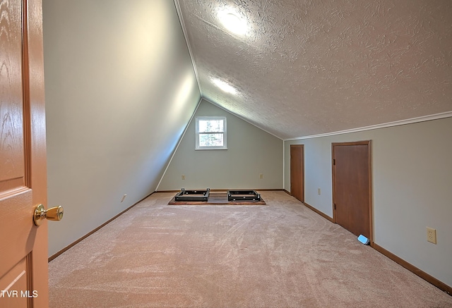 bonus room featuring light carpet, lofted ceiling, and a textured ceiling