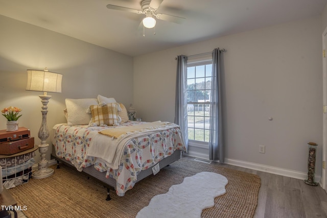 bedroom with hardwood / wood-style flooring and ceiling fan