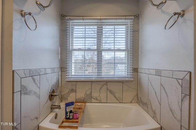 bathroom with a healthy amount of sunlight and a bathtub