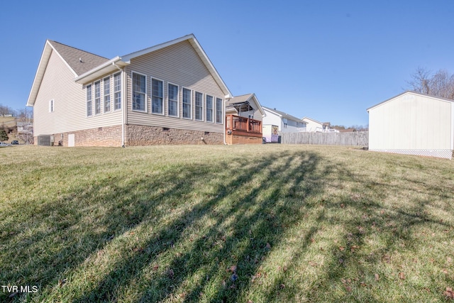 rear view of property featuring central AC and a yard