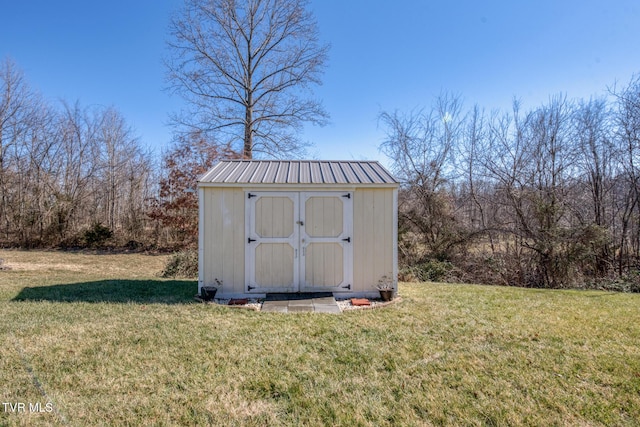 view of outbuilding featuring a yard