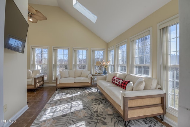 sunroom featuring lofted ceiling with skylight