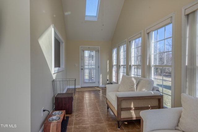 sunroom / solarium featuring vaulted ceiling with skylight