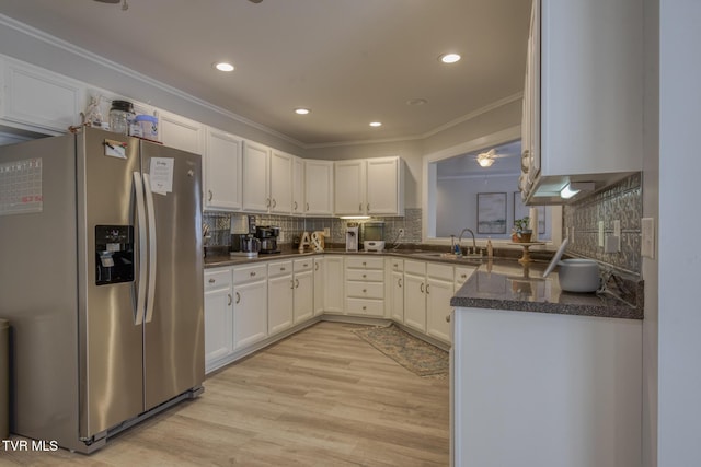 kitchen with sink, stainless steel fridge, light hardwood / wood-style flooring, white cabinetry, and ornamental molding