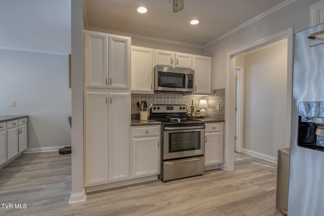 kitchen with stainless steel appliances, tasteful backsplash, white cabinets, and light wood-type flooring