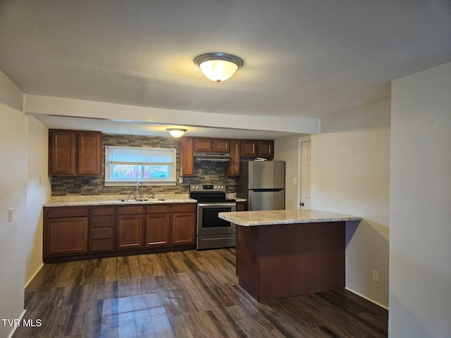 kitchen featuring sink, dark wood-type flooring, stainless steel appliances, tasteful backsplash, and light stone countertops