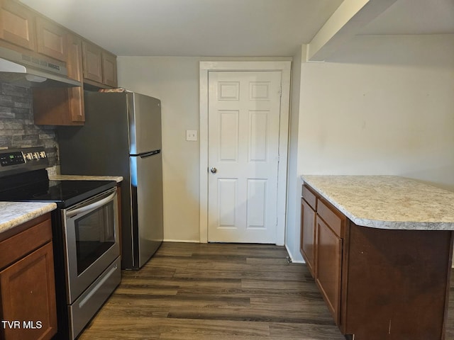 kitchen featuring decorative backsplash, dark hardwood / wood-style flooring, and stainless steel electric range