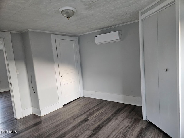 unfurnished bedroom featuring ornamental molding, dark wood-type flooring, a wall unit AC, and a closet