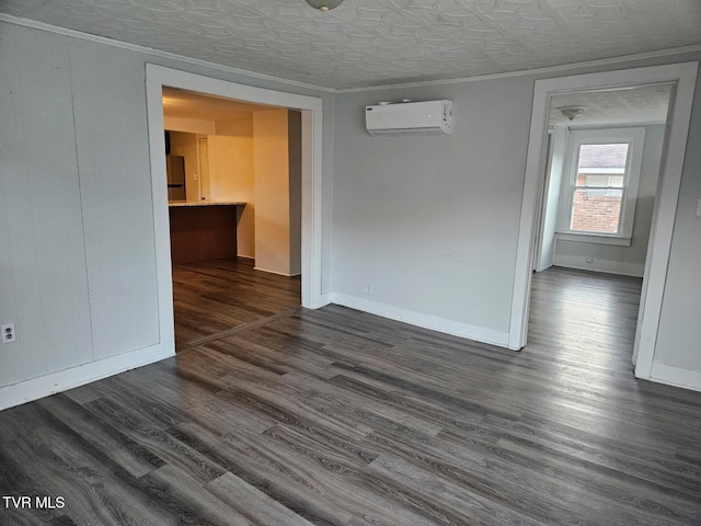 unfurnished room featuring crown molding, dark wood-type flooring, and an AC wall unit