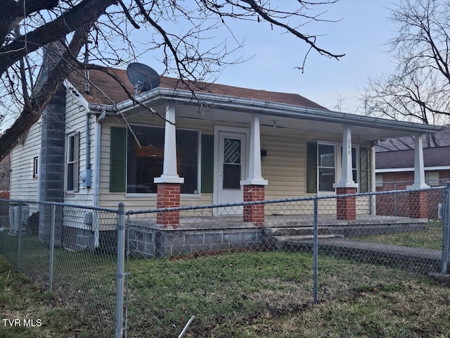 view of front of house with a front yard and a porch