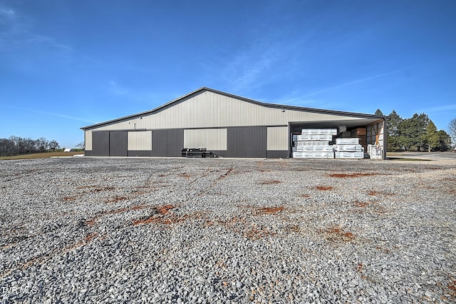 view of side of home featuring an outbuilding