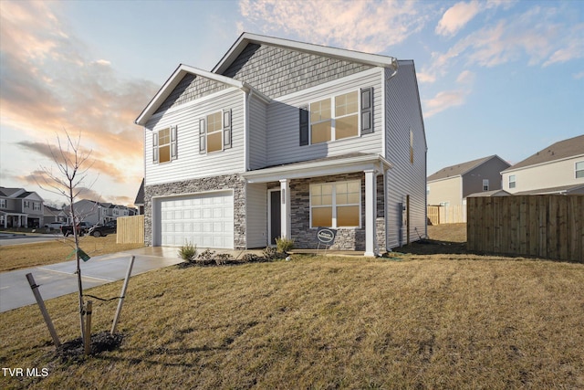 view of front facade featuring a garage and a lawn