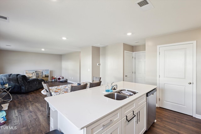 kitchen featuring white cabinetry, sink, stainless steel dishwasher, dark wood-type flooring, and a center island with sink