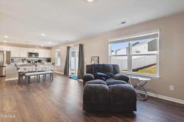 living room with dark hardwood / wood-style flooring