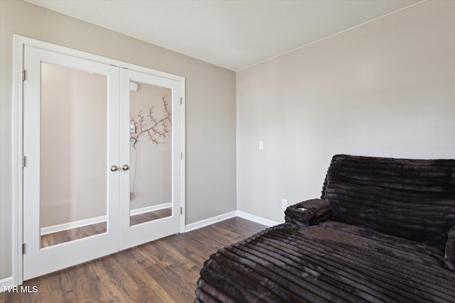 living area with dark wood-type flooring and french doors