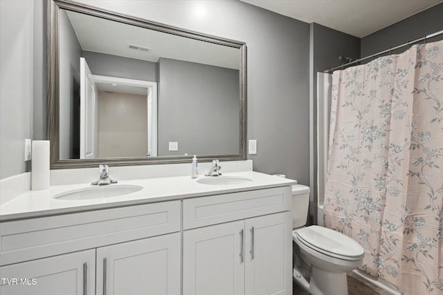 full bathroom featuring shower / tub combo, vanity, and toilet