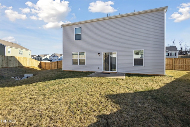 back of house featuring a yard and a patio