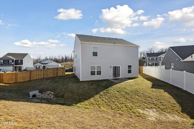 rear view of house featuring a yard