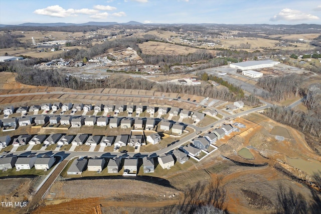 birds eye view of property with a mountain view