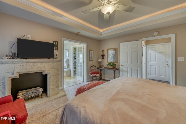 bedroom featuring light carpet, a raised ceiling, and ceiling fan