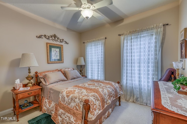 carpeted bedroom with lofted ceiling and ceiling fan