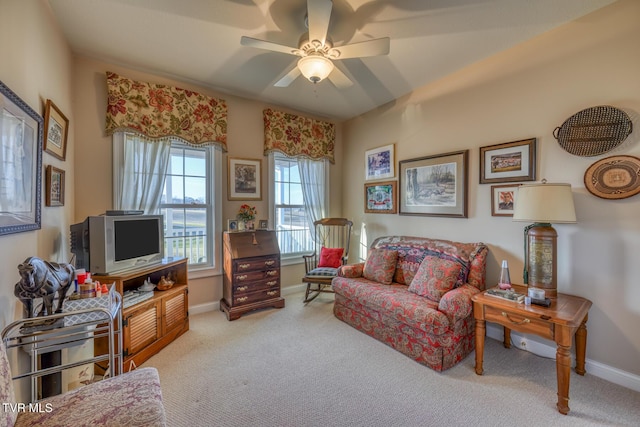 carpeted living room with ceiling fan