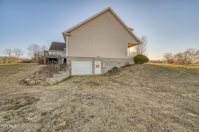 property exterior at dusk with a garage and a lawn