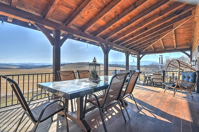 wooden terrace with a bar, a mountain view, and a gazebo