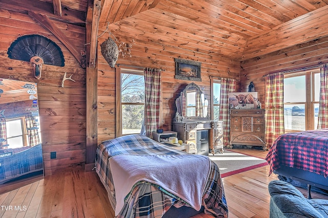 bedroom with wood ceiling, hardwood / wood-style floors, and wood walls