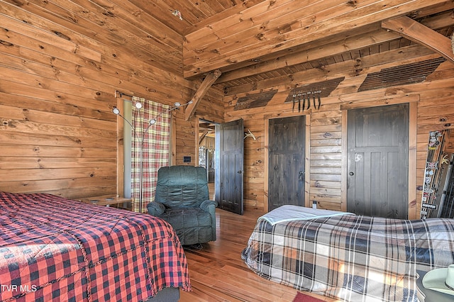 bedroom featuring light hardwood / wood-style floors, wood ceiling, and wood walls