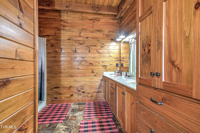 bathroom with vanity and wood walls