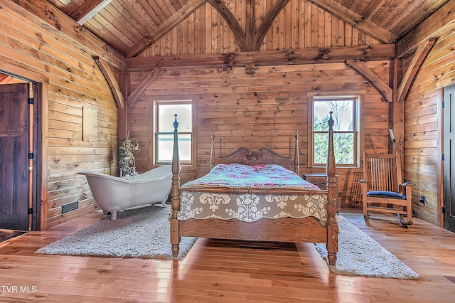 bedroom featuring wood ceiling, high vaulted ceiling, wooden walls, and hardwood / wood-style floors