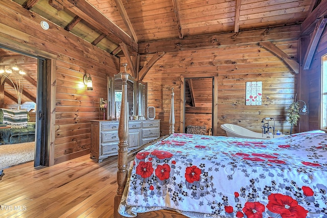 bedroom featuring hardwood / wood-style floors, wood ceiling, wooden walls, and lofted ceiling with beams