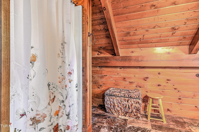 bathroom featuring wooden walls