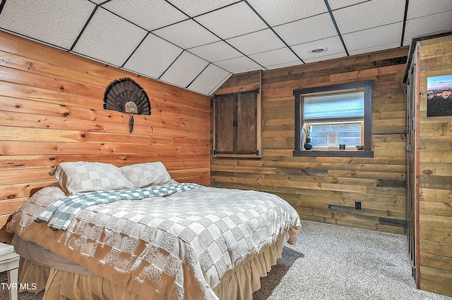 carpeted bedroom with wooden walls