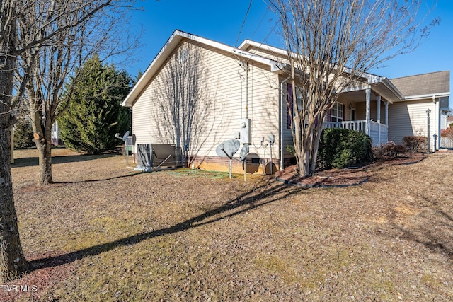 view of property exterior featuring central AC and a yard