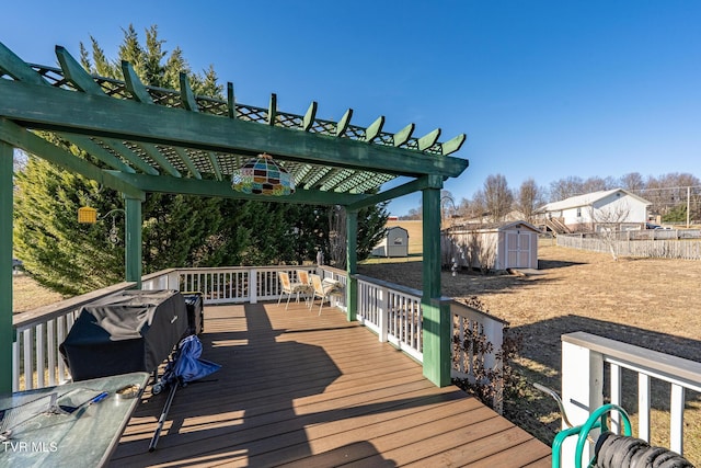 deck with a pergola, area for grilling, and a storage unit