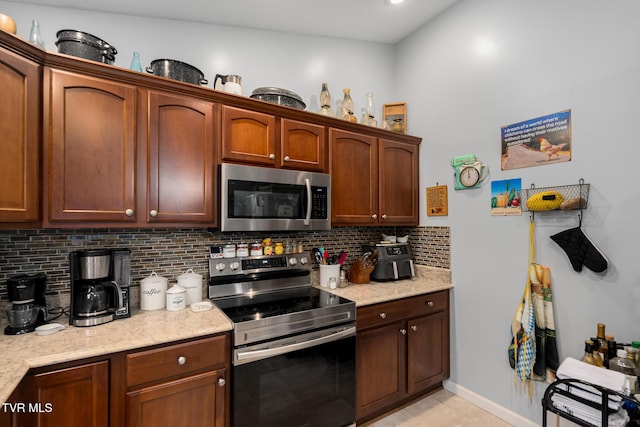 kitchen with backsplash and stainless steel appliances