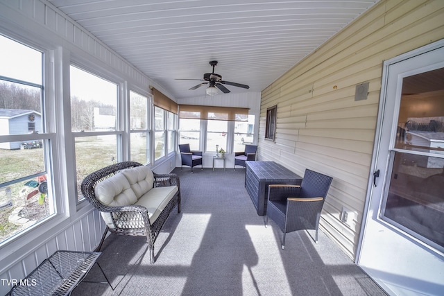 sunroom featuring ceiling fan