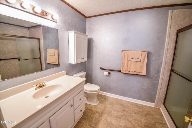 bathroom featuring toilet, a textured ceiling, ornamental molding, vanity, and a shower with door