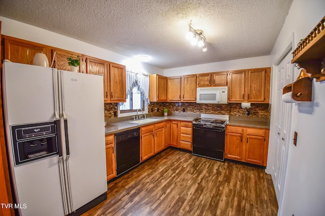 kitchen with sink, black appliances, a textured ceiling, dark hardwood / wood-style flooring, and backsplash