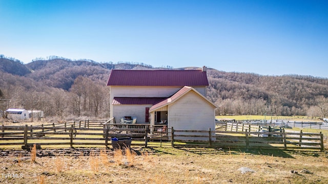 view of stable featuring a mountain view and a rural view