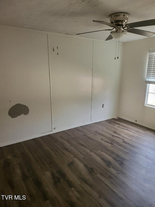 spare room with wood-type flooring, ceiling fan, and a textured ceiling