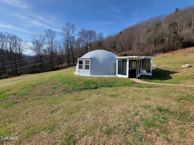 view of yard with a wooded view