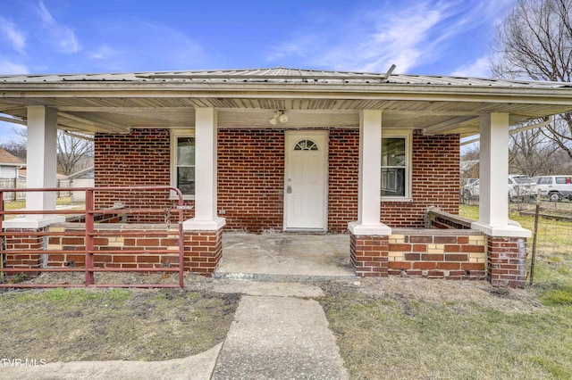 view of exterior entry with a porch